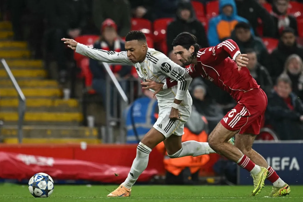 Real Madrid's French forward #10 Kylian Mbappe (L) vies with Liverpool's Hungarian midfielder #08 Dominik Szoboszlai (R) during the UEFA Champions League, league phase football match between Liverpool and Real Madrid at Anfield in Liverpool, north west England on November 4, 2025. (Photo by Paul ELLIS / AFP)