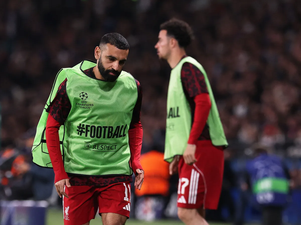 Liverpool's Egyptian striker #11 Mohamed Salah runs along the touch line during the  UEFA Champions League quarter-final first leg football match between Paris Saint-Germain (PSG) and Liverpool FC at the Parc des Princes stadium in Paris on April 8, 2026. (Photo by FRANCK FIFE / AFP)
