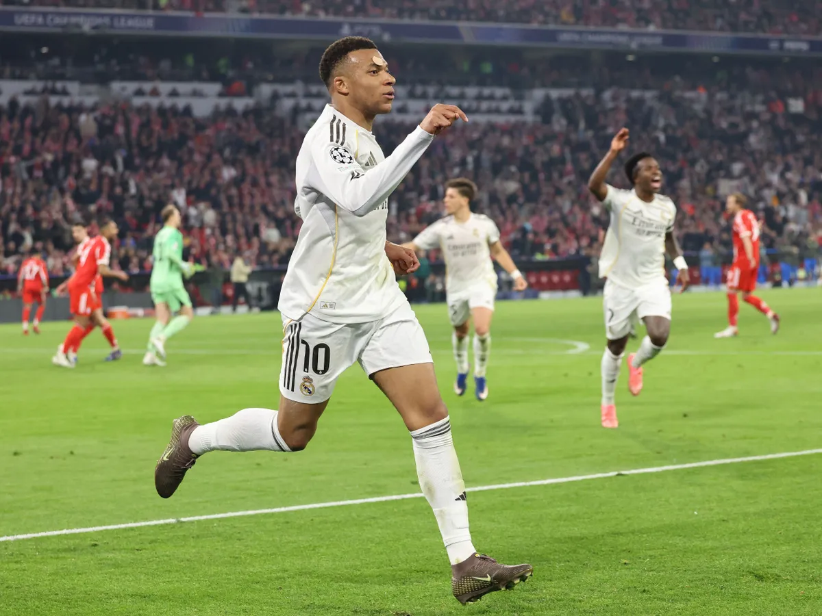 Real Madrid's French forward #10 Kylian Mbappe celebrates scoring the 2-3 goal with his teammates during the UEFA Champions League quarter-final second leg football match between FC Bayern Munich and Real Madrid in Munich, southern Germany, on April 15, 2026. (Photo by Alexandra BEIER / AFP)