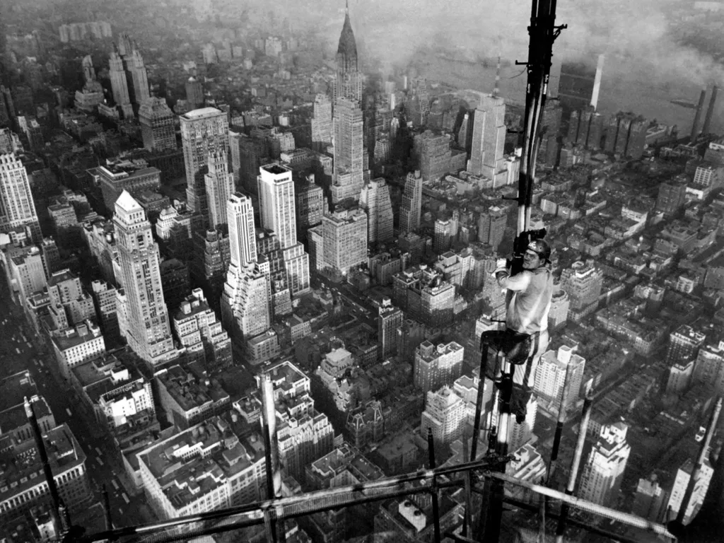 Empire State Building, EmpireStateBuilding, 
  Temporary television antenna is adjusted by a worker of US Steel's American Bridge Company atop the Empire State Building on October 26, 1950 in New-York. In the background is the Chrysler building (C). (Phot