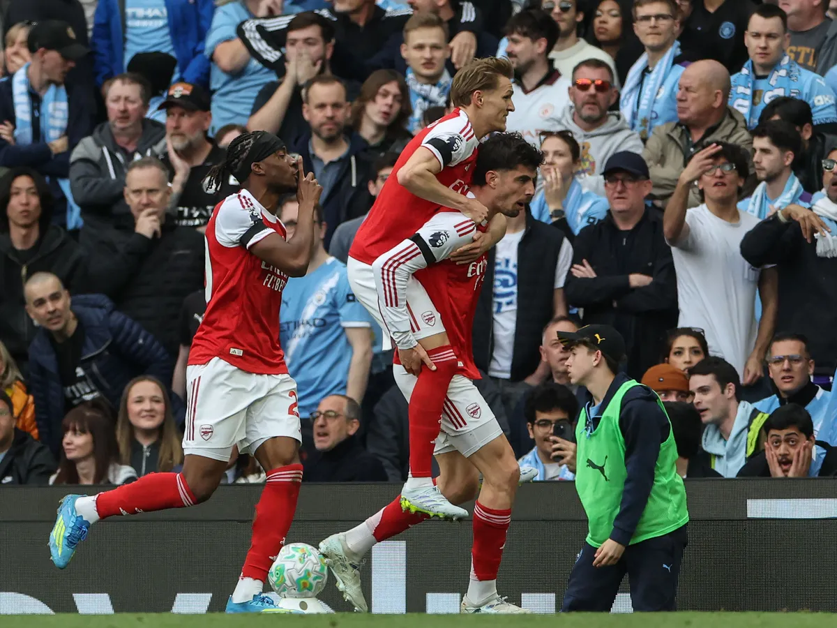 Arsenal's German midfielder #29 Kai Havertz (R-bottom) celebrates after scoring his team's first goal during the English Premier League football match between Manchester City and Arsenal at the Etihad Stadium in Manchester, north west England, on April 19, 2026. (Photo by Darren Staples / AFP) / RESTRICTED TO EDITORIAL USE. No use with unauthorized audio, video, data, fixture lists, club/league logos or 'live' services. Online in-match use limited to 120 images. An additional 40 images may be used in extra time. No video emulation. Social media in-match use limited to 120 images. An additional 40 images may be used in extra time. No use in betting publications, games or single club/league/player publications. /