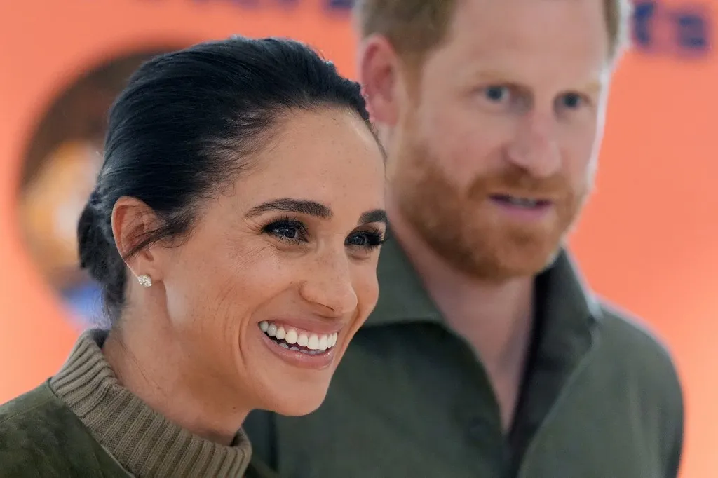 Britain's Prince Harry (R), Duke of Sussex, and his wife Meghan Markle (L), the Duchess of Sussex, arrive at the Australian National Veterans Arts Museum (ANVAM) in Melbourne on April 14, 2026. (Photo by Jonathan Brady / POOL / AFP)