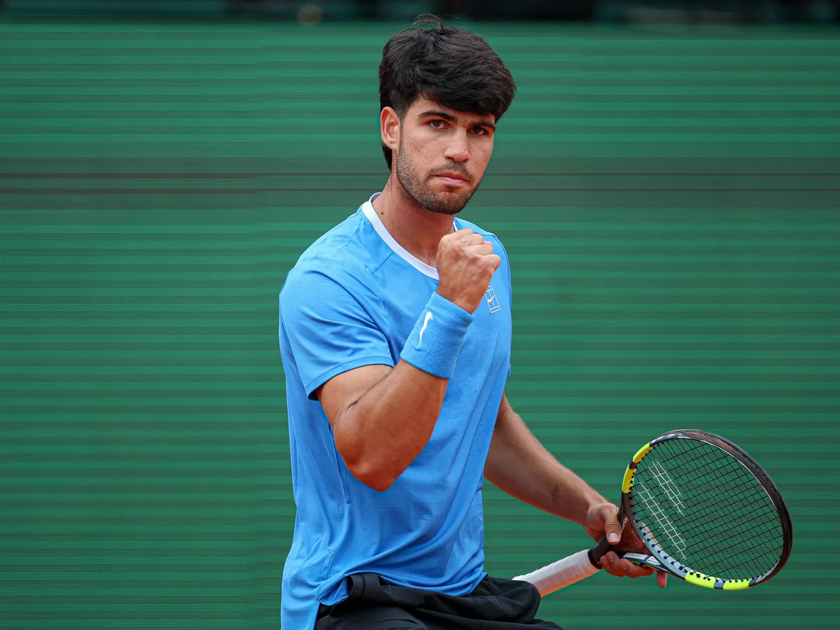 Spain's Carlos Alcaraz reacts after a point against Italy's Jannik Sinner during the Monte Carlo ATP Masters Series Tournament final tennis match on Court Rainier III at the Monte-Carlo Country Club in Roquebrune-Cap-Martin, south-eastern France on April 12, 2026. (Photo by Valery HACHE / AFP)