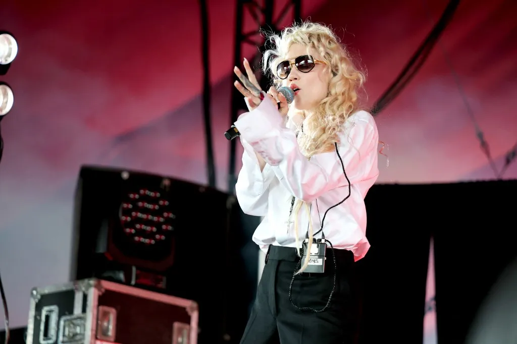 INDIO, CALIFORNIA - APRIL 12: (FOR EDITORIAL USE ONLY) (NOT TO BE LICENSED FOR ANY STANDALONE OR SPECIAL INTEREST BOOK PUBLISHING USE CONCERNING THE COACHELLA MUSIC FESTIVAL AND/OR STAGECOACH MUSIC FESTIVAL) Grimes performs with Cobrah at the Gobi Tent during the 2026 Coachella Valley Music and Arts Festival at Empire Polo Club on April 12, 2026 in Indio, California.   Amy Sussman/Getty Images for Coachella/AFP (Photo by Amy Sussman / GETTY IMAGES NORTH AMERICA / Getty Images via AFP)