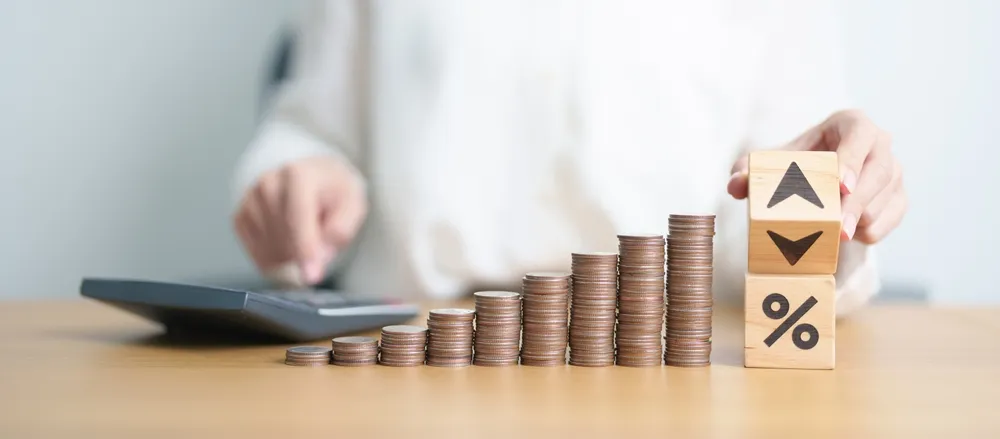 wood block of percentage change to UP and Down arrow with money coins stack. Interest rate, GDP, stocks market, financial, deflation and Inflation, ranking, mortgage, debt, Loan and Economic Recession
