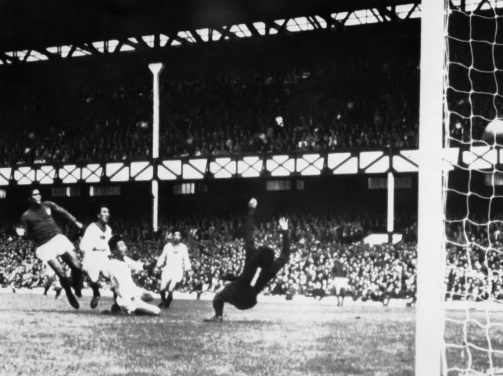 Portuguese forward Eusebio (L) scores the opening goal for his team past North Korean goalkeeper Lee Chang Myung during their quarterfinal match on July 23, 1966 in Liverpool. Down 3-0 after 25 minutes, Portugal came back to beat North Korea 5-3 as Eusebio scored four goals in a row, two in each half. (Photo by AFP)