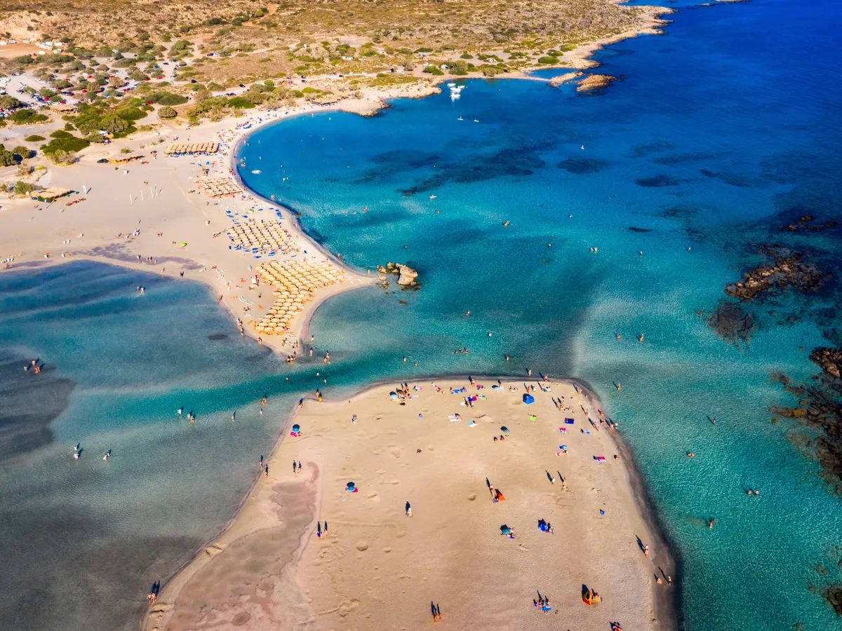 Aerial drone shot of beautiful turquoise beach with pink sand Elafonissi, Crete, Greece. Best beaches of Mediterranean, Elafonissi beach, Crete, Greece. Famous Elafonisi beach on Greece island, Crete.