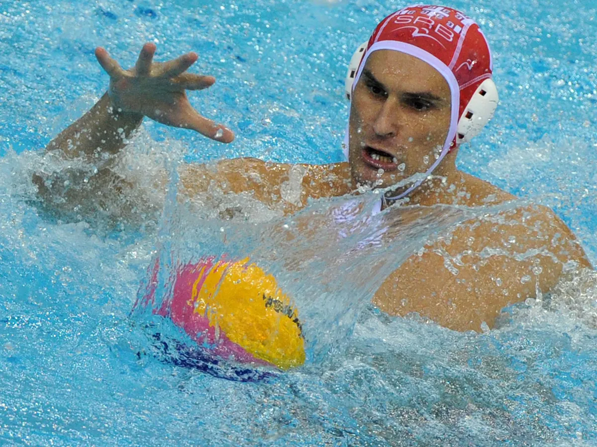 Serbia's goalkeeper Slobodan Soro  reaches for the ball after a shot from Italy during their men's water polo final match of the FINA World Championships at the natatorium of the Oriental Sports Center in Shanghai on July 30, 2011.        AFP PHOTO/Mark RALSTON (Photo by MARK RALSTON / AFP)