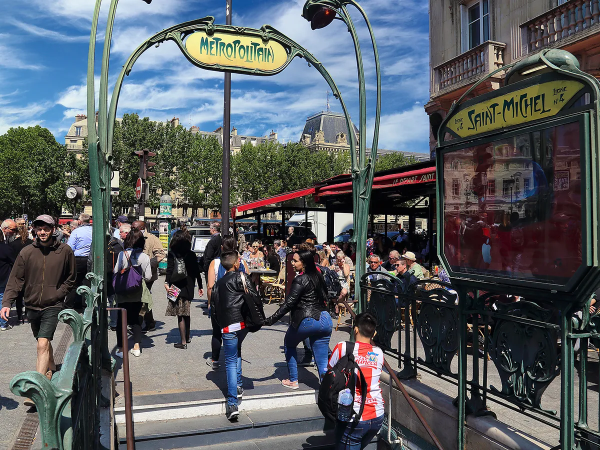 Paris, France - May 19, 2018: People at the entrance of the subway of Boulevard Saint-Michel in Paris, France on May 19, 2018