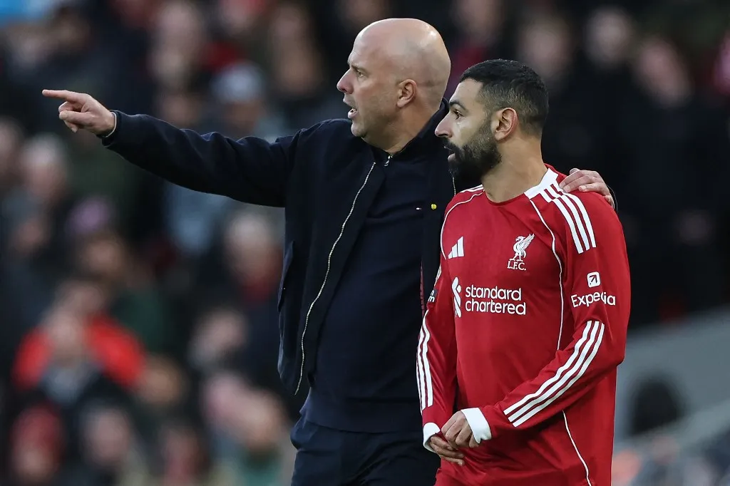 Liverpool's Dutch manager Arne Slot (L) substitutes in Liverpool's Egyptian striker #11 Mohamed Salah (R) in the second half during the English Premier League football match between Liverpool and Tottenham Hotspur at Anfield in Liverpool, north west England on March 15, 2026. (Photo by Darren Staples / AFP) / RESTRICTED TO EDITORIAL USE. No use with unauthorized audio, video, data, fixture lists, club/league logos or 'live' services. Online in-match use limited to 120 images. An additional 40 images may be used in extra time. No video emulation. Social media in-match use limited to 120 images. An additional 40 images may be used in extra time. No use in betting publications, games or single club/league/player publications. / 