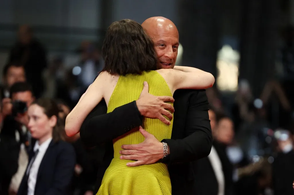US actor Vin Diesel embraces US model and actress Meadow Rain Walker as they arrive for the screening of the film "The Fast and the Furious" at the 79th edition of the Cannes Film Festival in Cannes, southern France on May 13, 2026. (Photo by Thibaud MORITZ / AFP)