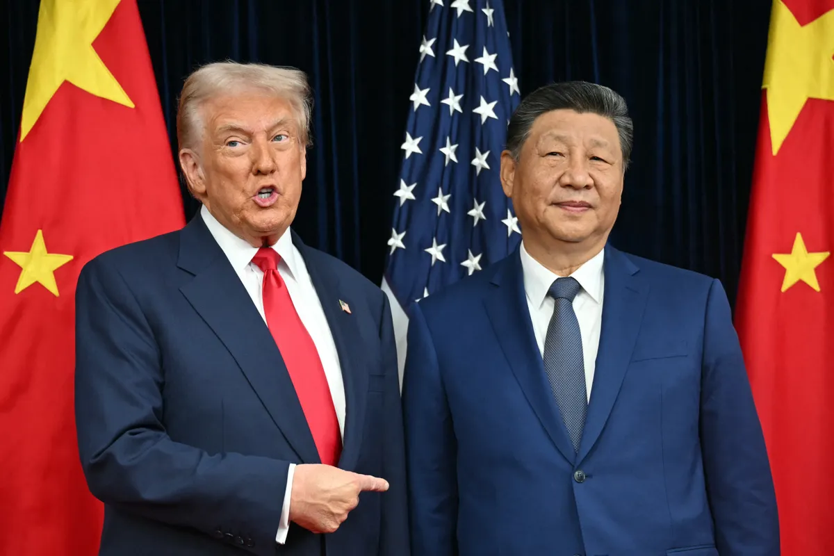 (FILES) US President Donald Trump (L) and China's President Xi Jinping greet each other as they arrive for talks at the Gimhae Air Base, located next to the Gimhae International Airport in Busan on October 30, 2025. US President Donald Trump is due to visit China on May 14-15, 2026, where he is expected to meet with leader Xi Jinping, after delaying an earlier summit because of the Iran war. (Photo by ANDREW CABALLERO-REYNOLDS / AFP)