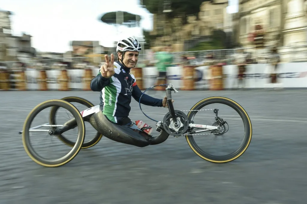 (FILES) Former driver and paracyclist Alex Zanardi runner takes part in the 22nd Marathon of Rome near the Coliseum on April 10, 2016. Alex Zanardi, the Italian racing car driver who became a Paralympic cycling champion after losing both legs in an accident, has died aged 59, his family announced on May 2, 2026. Zanardi, one of his country's most loved and respected sportsmen, who as credited with helping transformed the perception of disability in Italy, died on the evening of May 1. (Photo by ANDREAS SOLARO / AFP)