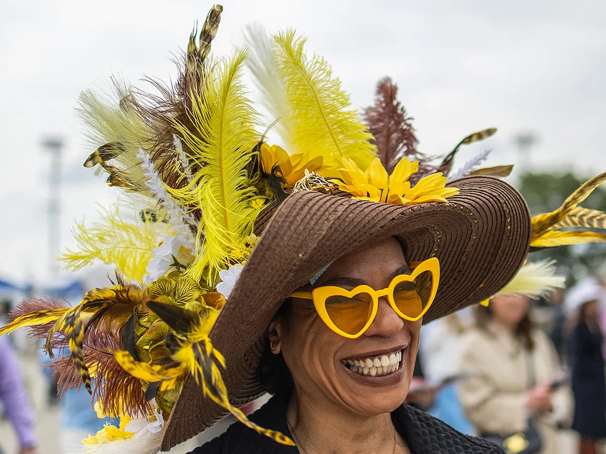 An attendee arrives to the 152nd running of the Kentucky Derby at Churchill Downs in Louisville, Kentucky, on May 2, 2026. (Photo by Leandro Lozada / AFP)