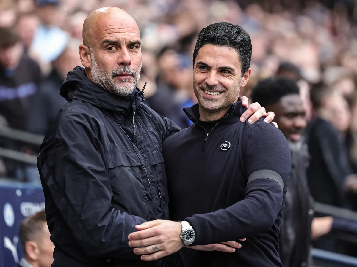 Pep Guardiola, manager of Manchester City, greets Mikel Arteta, manager of Arsenal, during the Premier League match between Manchester City and Arsenal at Etihad Stadium in Manchester, United Kingdom, on April 19, 2026. (Photo by Mark Cosgrove/News Images/NurPhoto) (Photo by News Images / NurPhoto via AFP)