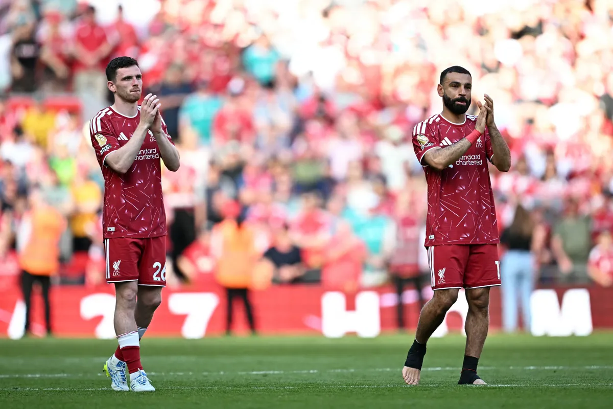 Liverpool's Scottish defender #26 Andrew Robertson (L) and Liverpool's Egyptian striker #11 Mohamed Salah clap the fans on the pitch after the English Premier League football match between Liverpool and Brentford at Anfield in Liverpool, north west England on May 24, 2026. (Photo by Paul ELLIS / AFP) / RESTRICTED TO EDITORIAL USE. No use with unauthorized audio, video, data, fixture lists, club/league logos or 'live' services. Online in-match use limited to 120 images. An additional 40 images may be used in extra time. No video emulation. Social media in-match use limited to 120 images. An additional 40 images may be used in extra time. No use in betting publications, games or single club/league/player publications. /