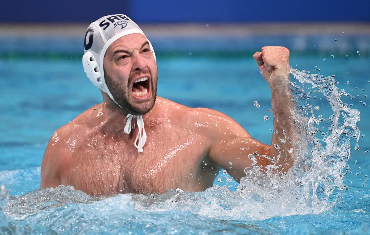 Serbia's Filip Filipovic celebates winning the Tokyo 2020 Olympic Games men's water polo semi-final match between Serbia and Spain at the Tatsumi Water Polo Centre in Tokyo on August 6, 2021. (Photo by Martin BERNETTI / AFP)