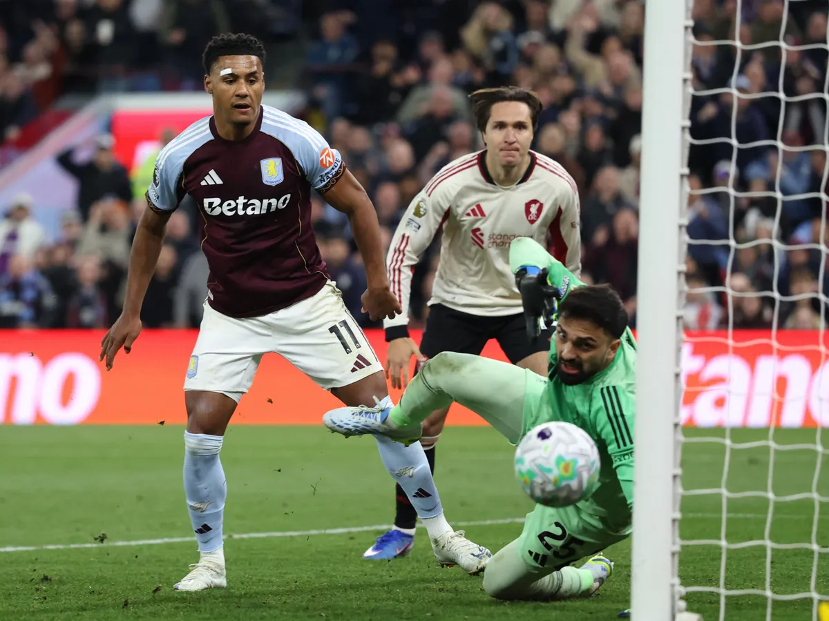 Aston Villa's English striker #11 Ollie Watkins (C) watches his shot beat Liverpool's Georgian goalkeeper #25 Giorgi Mamardashvili for their third goal during the English Premier League football match between Aston Villa and Liverpool at Villa Park in Birmingham, central England on May 15, 2026. (Photo by Darren Staples / AFP) / RESTRICTED TO EDITORIAL USE. No use with unauthorized audio, video, data, fixture lists, club/league logos or 'live' services. Online in-match use limited to 120 images. An additional 40 images may be used in extra time. No video emulation. Social media in-match use limited to 120 images. An additional 40 images may be used in extra time. No use in betting publications, games or single club/league/player publications. / 