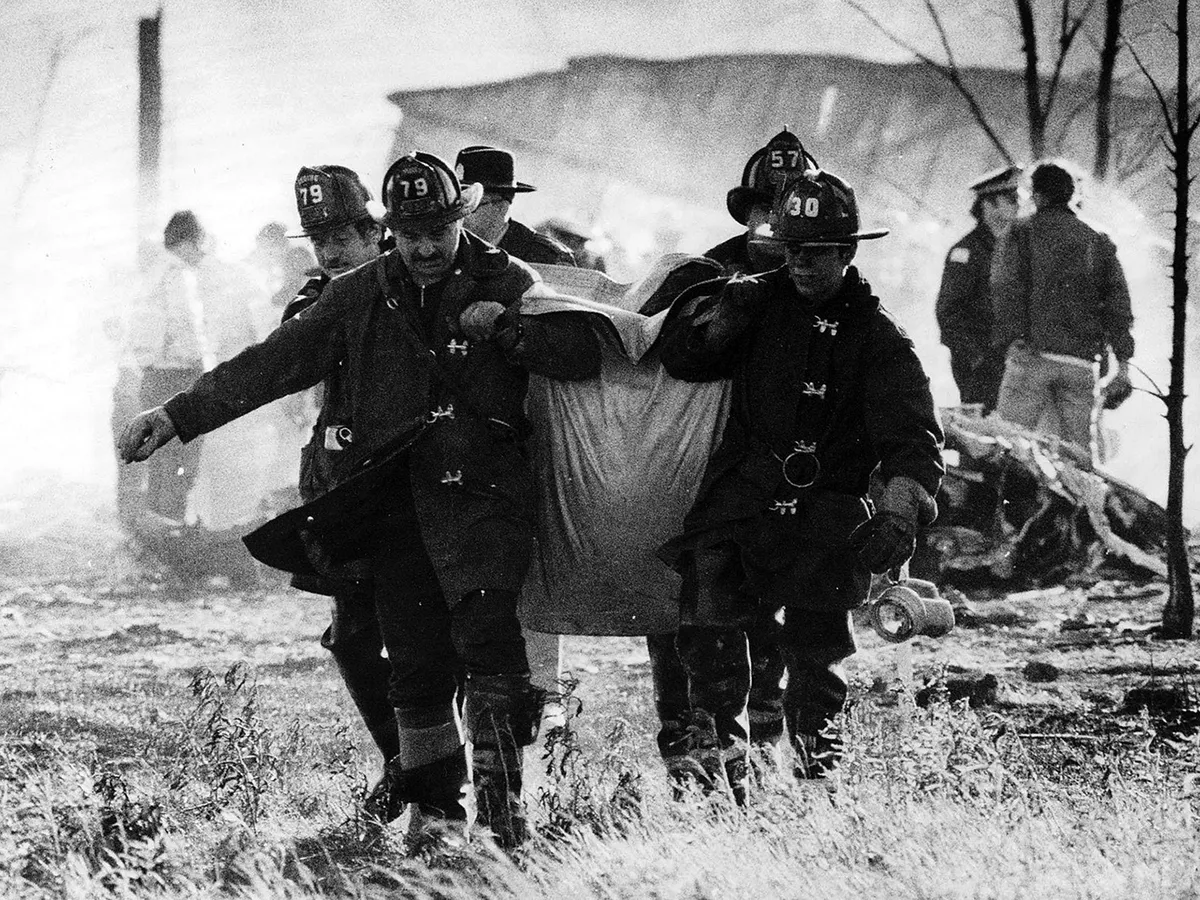 After the flames were doused, firefighters and rescue teams set out to find the remains of victims amid the smoldering debris from the American Airlines Flight 191 accident at O'Hare in May 1979. (Val Mazzenga/Chicago Tribune/Tribune News Service via Getty Images)