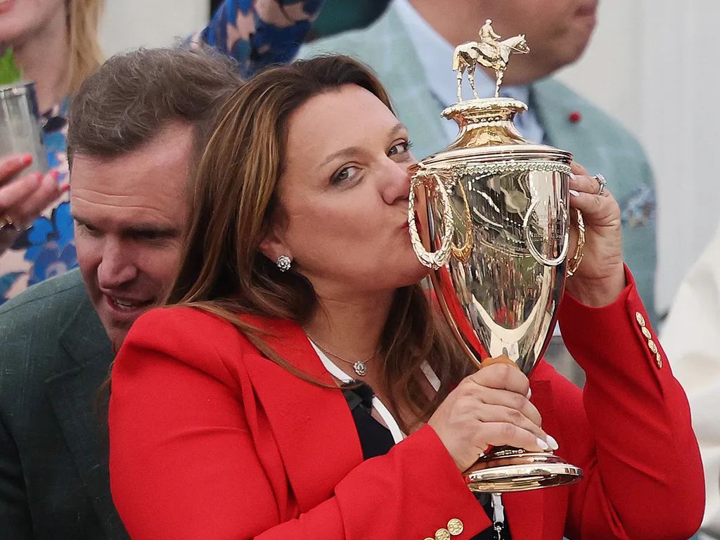 LOUISVILLE, KENTUCKY - MAY 02: Cherie DeVaux trainer of Golden Tempo #19, the first female trainer to win the Kentucky Derby, celebrates with the trophy in the winner's circle following the 152nd running of the Kentucky Derby at Churchill Downs on May 02,