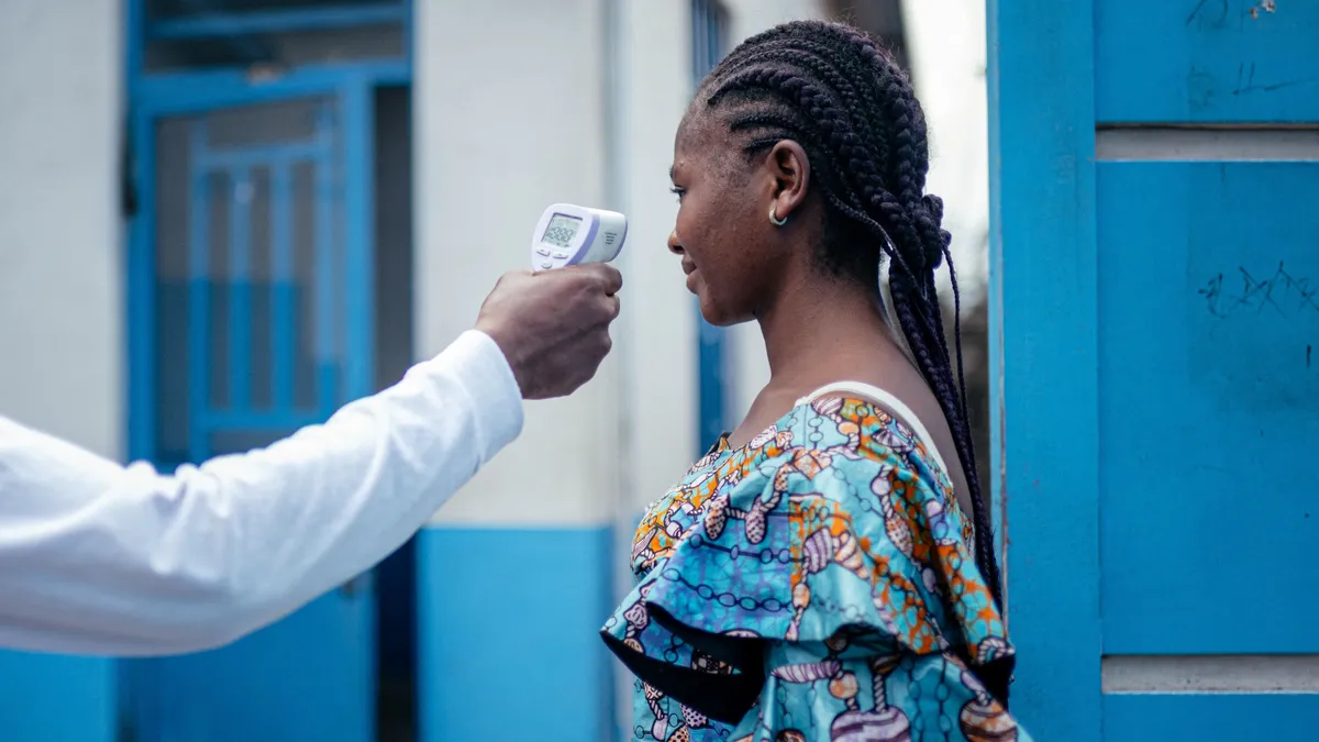A staff member of the CBCA Virunga Hospital checks a visitors temperature using a a contactless infrared thermometer, before allowing her access to the hospital in Goma on May 17, 2026. A first case of Ebola virus infection has been reported in Goma, a major city in eastern Democratic Republic of Congo controlled by the M23 armed group, with the WHO declaring an international health alert on Sunday.
According to figures released Saturday by the African Unions health agency (Africa CDC), 88 deaths likely caused by the virus have been recorded, out of 336 suspected cases. One death has been reported in neighboring Uganda. As the epicenter of the outbreak is located in a hard-to-reach area, few samples have been tested in laboratories and the figures are based largely on suspected cases. (Photo by Jospin Mwisha / AFP)