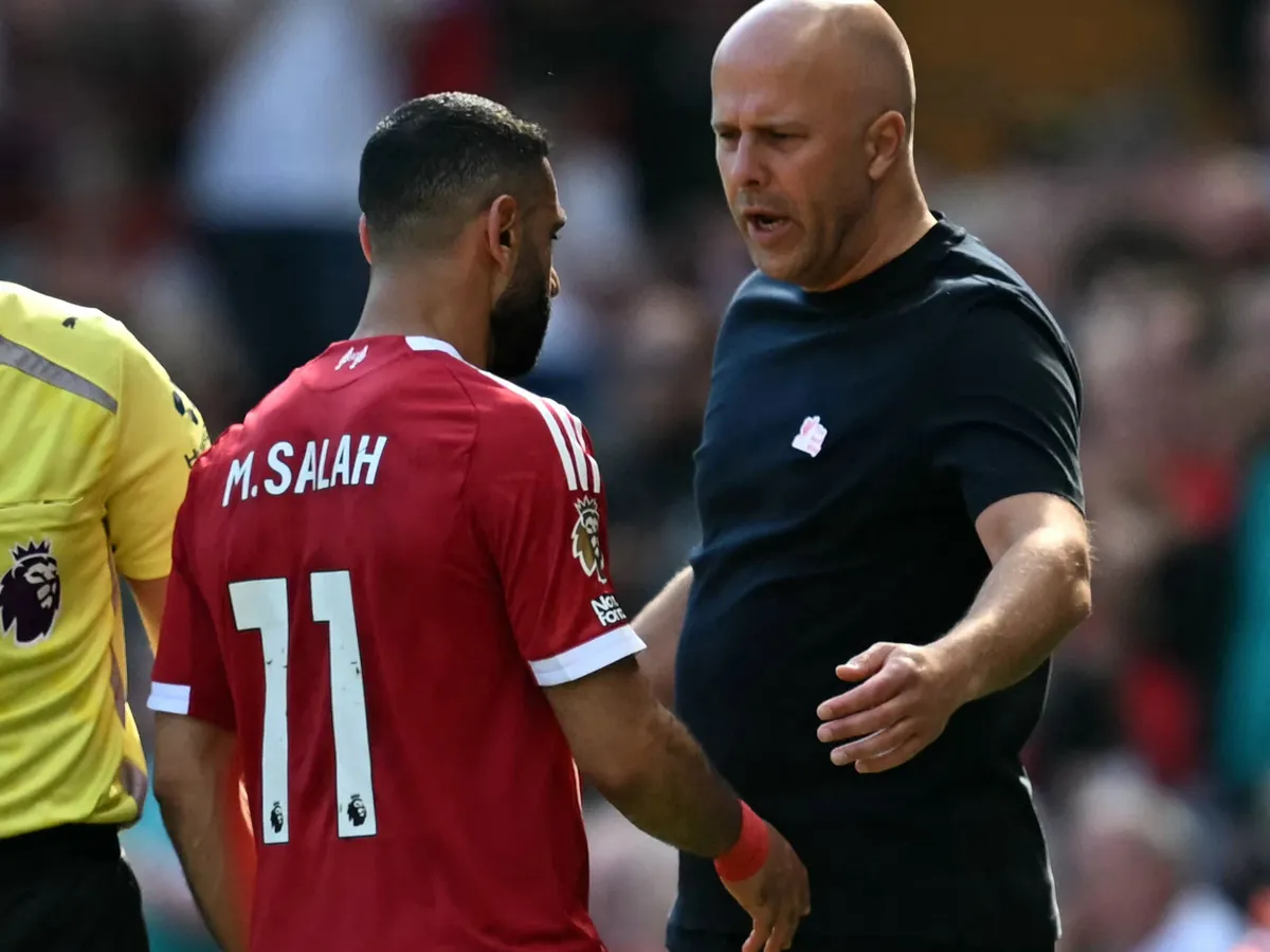 Liverpool's Egyptian striker #11 Mohamed Salah talks to Liverpool's Dutch manager Arne Slot as he leaves the pitch injured during the English Premier League football match between Liverpool and Crystal Palace at Anfield in Liverpool, north west England on April 25, 2026. (Photo by Paul ELLIS / AFP) / RESTRICTED TO EDITORIAL USE. No use with unauthorized audio, video, data, fixture lists, club/league logos or 'live' services. Online in-match use limited to 120 images. An additional 40 images may be used in extra time. No video emulation. Social media in-match use limited to 120 images. An additional 40 images may be used in extra time. No use in betting publications, games or single club/league/player publications. /
