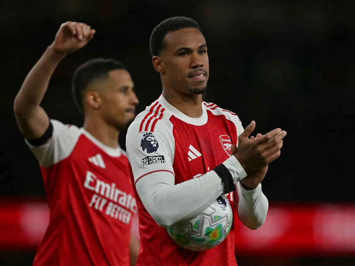 Arsenal's Brazilian defender #06 Gabriel Magalhaes (R) and Arsenal's French defender #02 William Saliba (L) celebrate their win after the English Premier League football match between Arsenal and Burnley at the Emirates Stadium in London on May 18, 2026. (Photo by Glyn KIRK / AFP) / RESTRICTED TO EDITORIAL USE. No use with unauthorized audio, video, data, fixture lists, club/league logos or 'live' services. Online in-match use limited to 120 images. An additional 40 images may be used in extra time. No video emulation. Social media in-match use limited to 120 images. An additional 40 images may be used in extra time. No use in betting publications, games or single club/league/player publications. / 