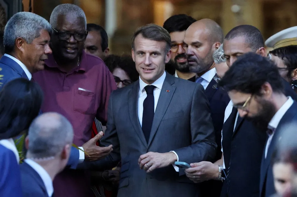 France's President Emmanuel Macron greets people during a visit to the Church of the Third Order of Our Lady of the Rosary of the Black People in Salvador, Bahia state, Brazil on November 5, 2025. (Photo by Ludovic MARIN / AFP)