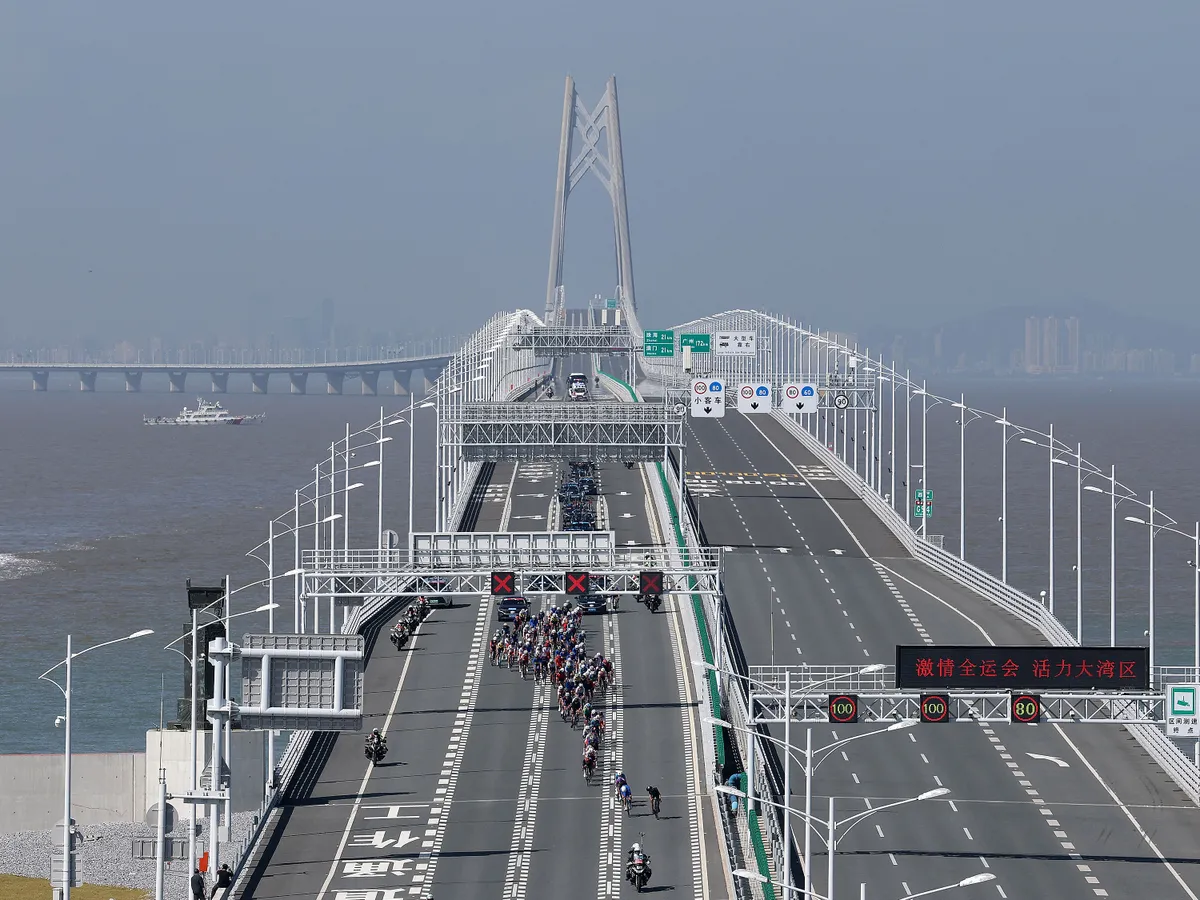 (251121) -- GUANGZHOU, Nov. 21, 2025 (Xinhua) -- Cyclists compete across the Hong Kong-Zhuhai-Macao Bridge during the men's road race of cycling road at China's 15th National Games in south China's Guangdong Province, Nov. 8, 2025. (Xinhua/Liang Xu) (Photo by Liang Xu / Xinhua via AFP)