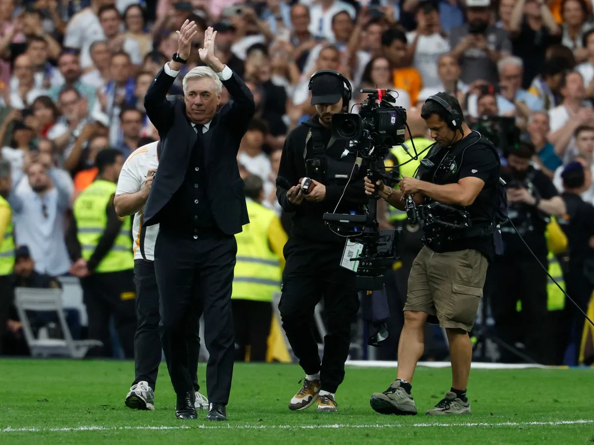 Real Madrid's Italian coach Carlo Ancelotti acknowledges fans at the end of the Spanish league football match between Real Madrid CF and Real Sociedad at Santiago Bernabeu Stadium in Madrid on May 24, 2025. (Photo by Pierre-Philippe MARCOU / AFP)