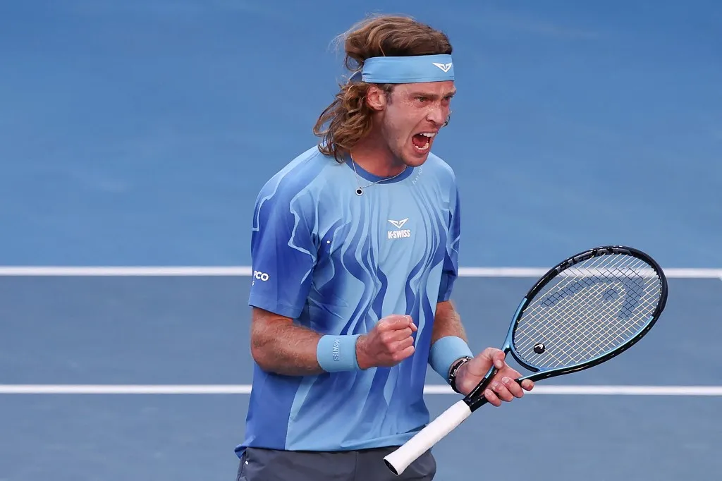 Russia's Andrey Rublev reacts after a point against Argentinas Francisco Cerundolo during their men's singles match on day six of the Australian Open tennis tournament in Melbourne on January 23, 2026. (Photo by Izhar Khan / AFP) / -- IMAGE RESTRICTED TO EDITORIAL USE - STRICTLY NO COMMERCIAL USE --
