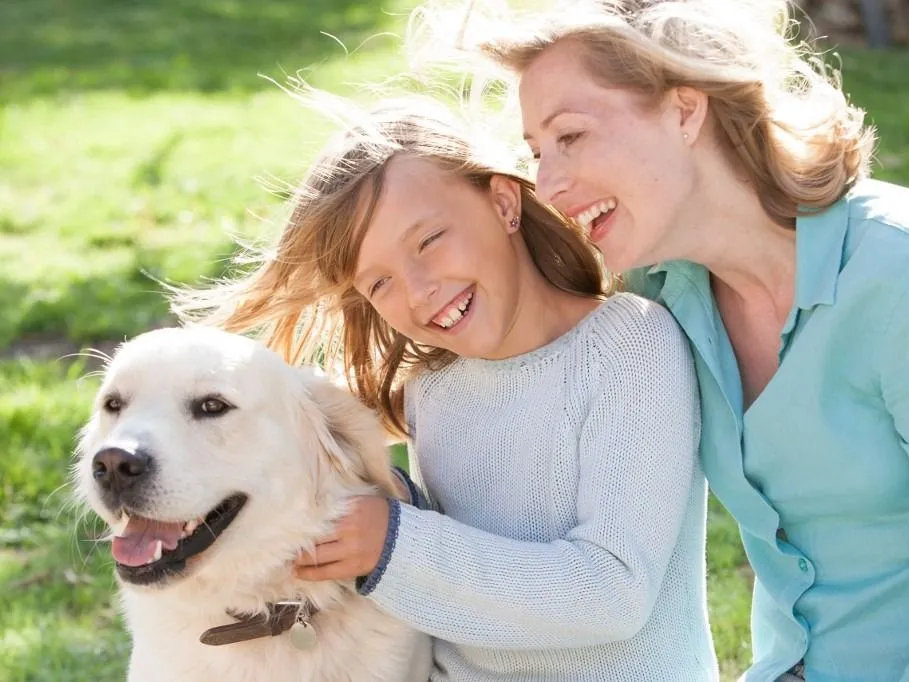 mosoly Mother and daughter in garden with dog smiling (Photo by RUSS ROHDE / Connect Images via AFP)