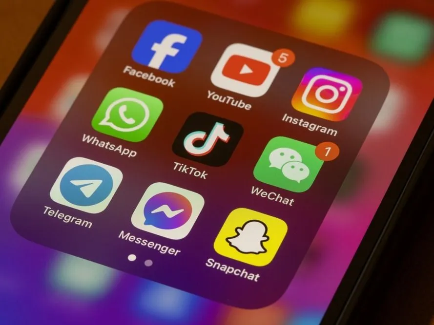 Portland, OR, USA - Nov 11, 2024: Assorted popular social media apps, including Facebook, YouTube, Instagram, WhatsApp, TikTok, WeChat, Telegram, Messenger, and Snapchat, are seen on an iPhone.