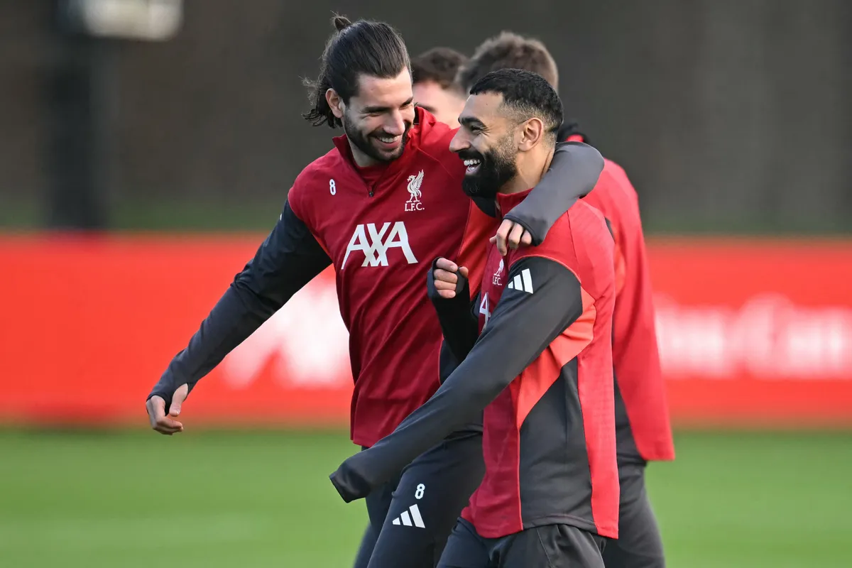 Liverpool's Hungarian midfielder #08 Dominik Szoboszlai (L) and Liverpool's Egyptian striker #11 Mohamed Salah (R) attend a team training session at their training ground in Kirkby, Liverpool, north-west England on December 8, 2025, on the eve of their UEFA Champions League, league phase football match against Inter Milan in Milan. Mohamed Salah plunged his future at Liverpool into serious doubt after claiming he had been made the fall guy for the Premier League champions' disastrous form this season. (Photo by Paul ELLIS / AFP)