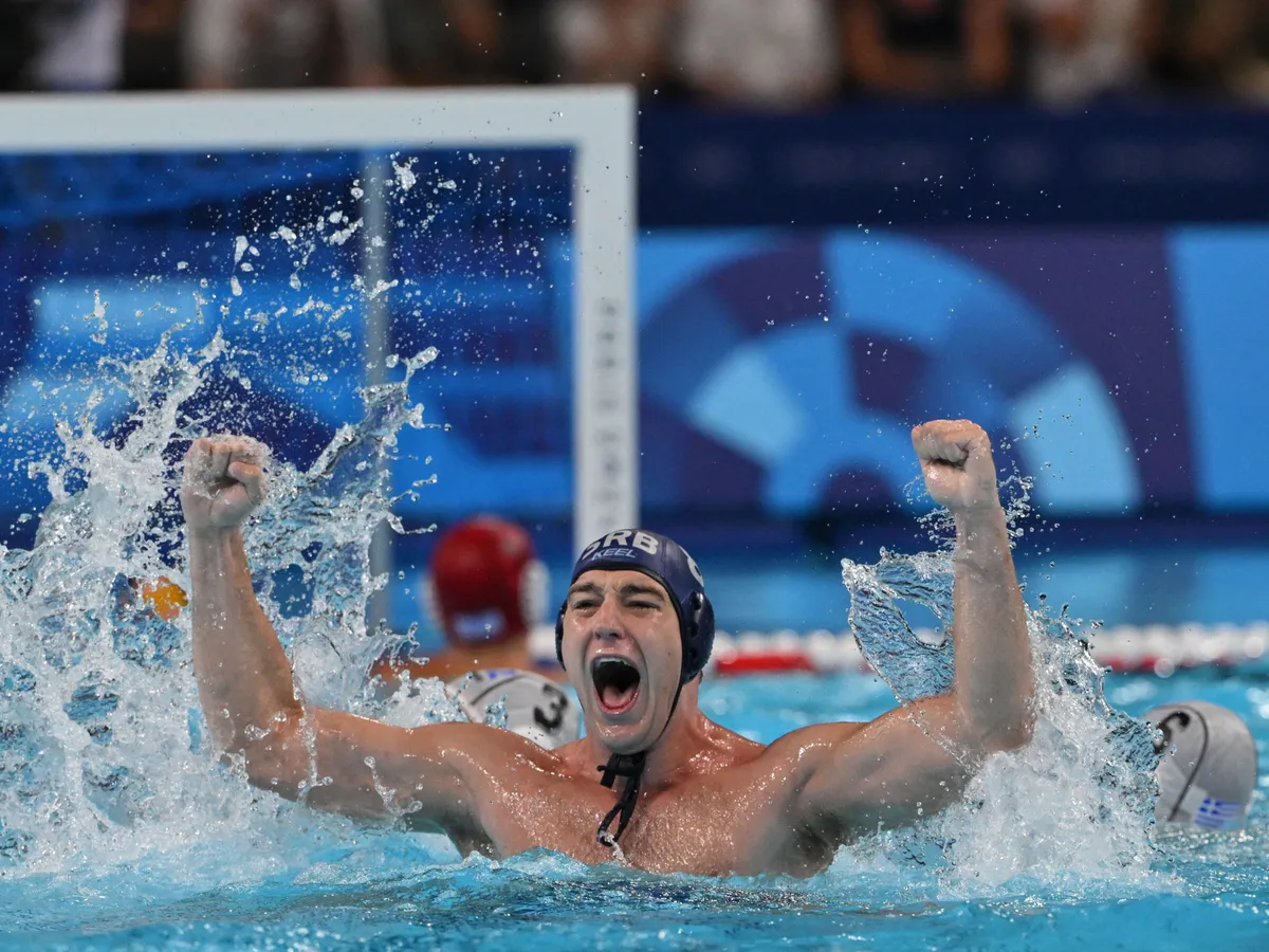Serbia's #08 Nikola Jaksic celebrates after winning in the men's water polo quarterfinal match between Greece and Serbia during the Paris 2024 Olympic Games at the Paris La Defense Arena in Paris on August 7, 2024. (Photo by Andreas SOLARO / AFP)