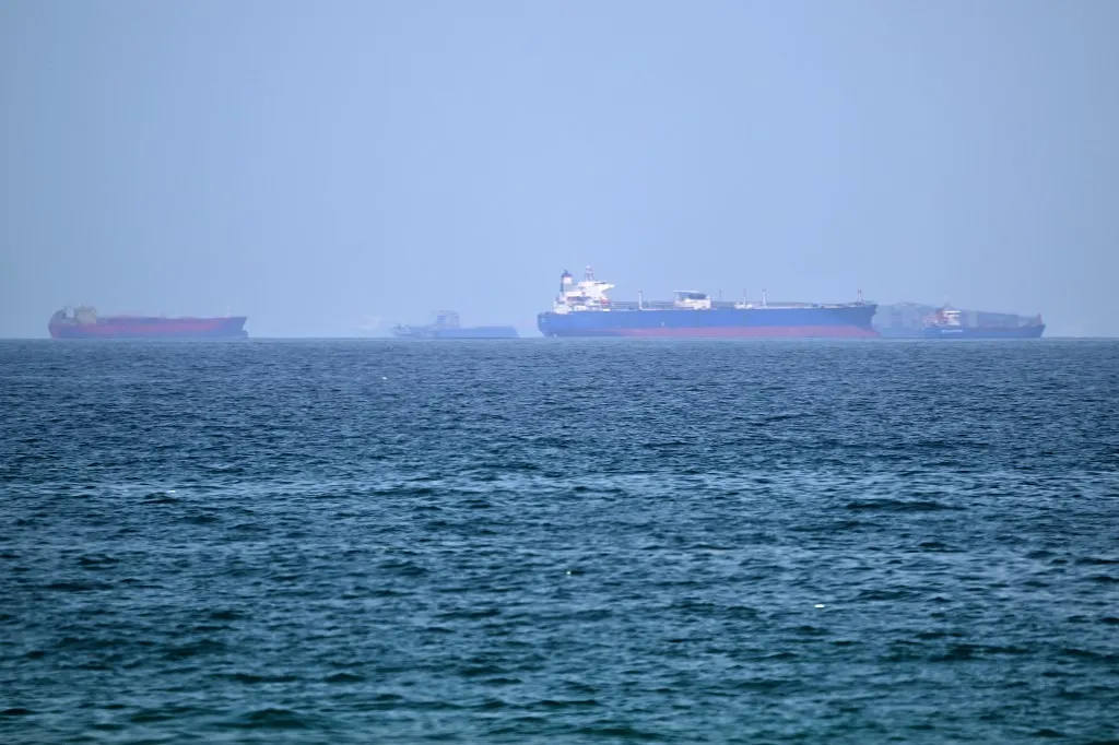 Vessels are pictured off coast of the Khor Fakkan Container Terminal, the only natural deep-sea port in the region and one of the major container ports in Sharjah Emirate, along the Gulf of Oman on June 28, 2026. Iran's top diplomat warned on June 28 that any attempt by shipping to bypass its preferred route through the Strait of Hormuz would "increase tensions" in the Middle East, as US and Iranian forces again traded attacks across the vital seaway. (Photo by AFP) /