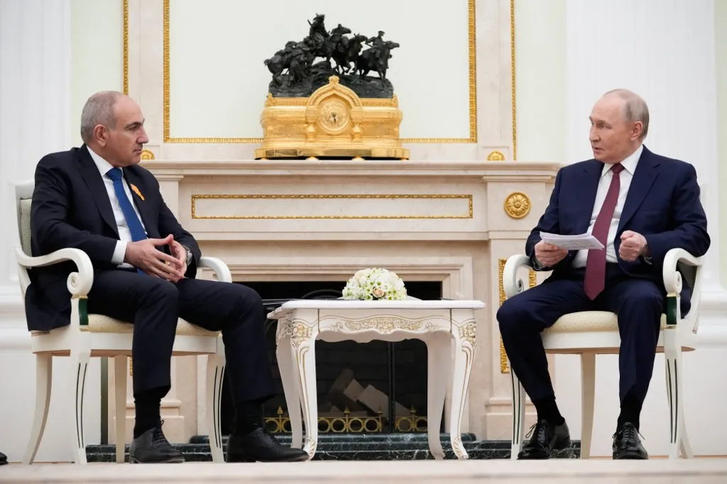 Russian President Vladimir Putin (R) speaks with Armenian Prime Minister Nikol Pashinyan during their meeting at the Kremlin in Moscow, on April 1, 2026. (Photo by Pavel Bednyakov / POOL / AFP)