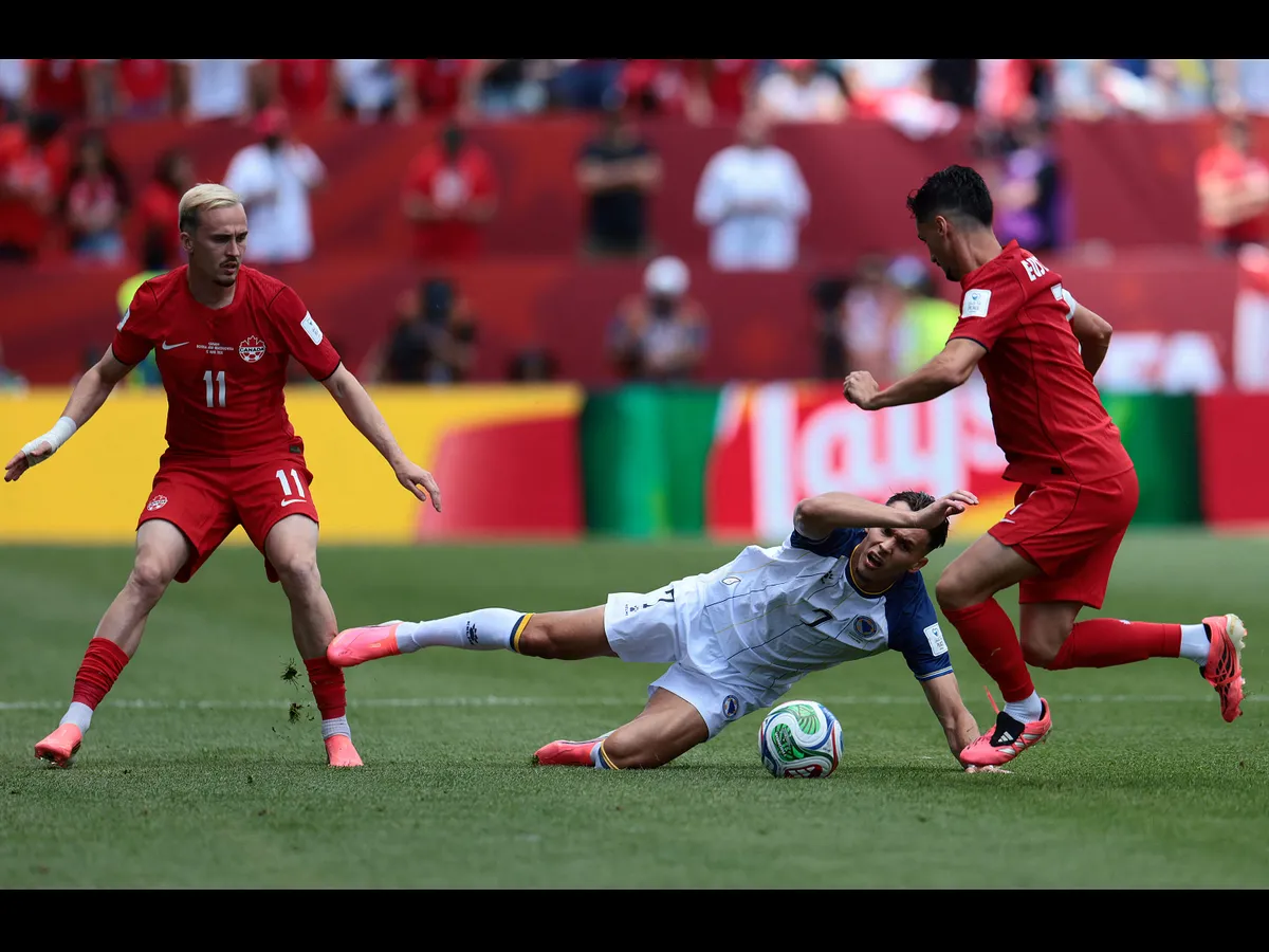Bosnia-Herzegovina's defender #07 Amar Dedic (C) fights for the ball with Canada's midfielder #11 Liam Millar (L) and Canada's midfielder #07 Stephen Eustaquio during the 2026 World Cup Group B football match between Canada and Bosnia and Herzegovina at the Toronto Stadium in Toronto on June 12, 2026. (Photo by Cole Burston / AFP)