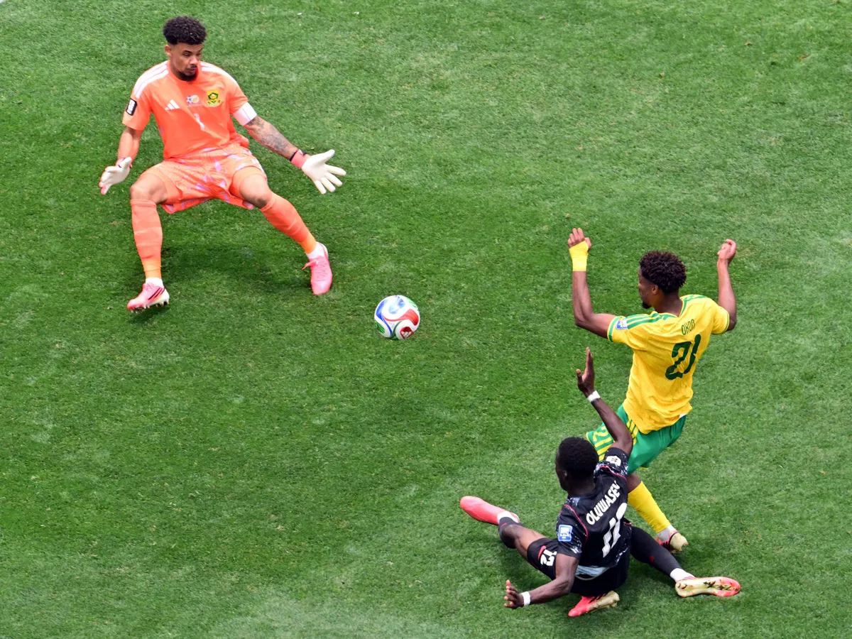 Canada's forward #12 Tani Oluwaseyi kicks the ball and misses a chance past South Africa's goalkeeper #01 Ronwen Williams and defender #21 Ime Okon during the 2026 World Cup round of 32 football match between South Africa and Canada at the Los Angeles Stadium in Inglewood on June 28, 2026. (Photo by Frederic J. Brown / AFP)