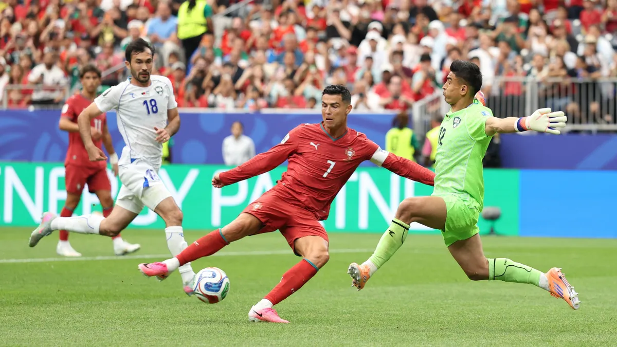 HOUSTON, TEXAS - JUNE 23: Cristiano Ronaldo #7 of Portugal shoots at goal blocked by Abduvohid Nematov #12 of Uzbekistan during the FIFA World Cup 2026 Group K match between Portugal and Uzbekistan at Houston Stadium on June 23, 2026 in Houston, Texas. Charlotte Wilson/Getty Images/AFP (Photo by Charlotte Wilson / GETTY IMAGES NORTH AMERICA / Getty Images via AFP)