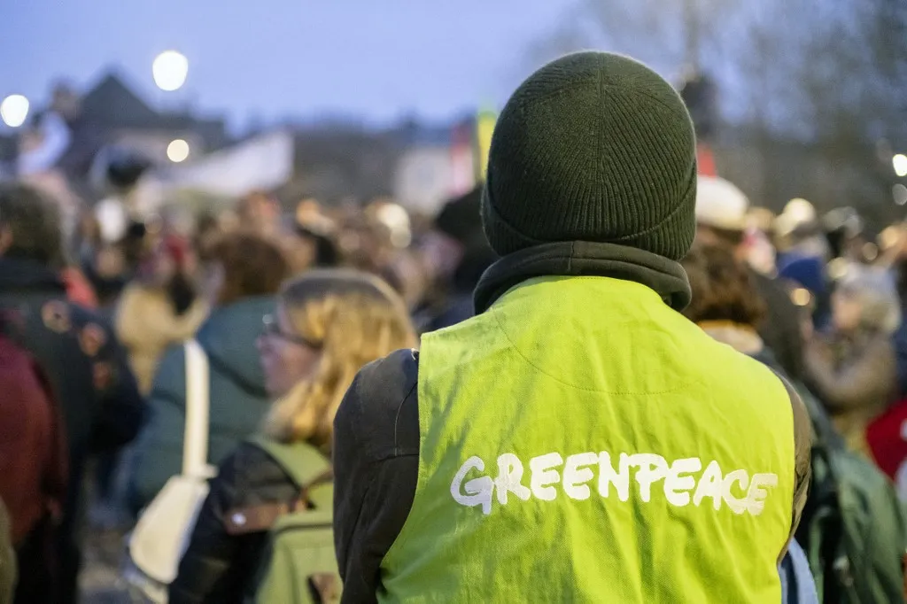 France, 2025-03-25. A Greenpeace activist wears his green vest emblazoned with the Greenpeace logo. Around 400 demonstrators gathered in Poitiers for the second anniversary of the Sainte Soline confrontation over mega-basins and the management and sharing of water resources by agriculture. The calm demonstration became tense as it approached a military barracks protected by a large police force. Photograph by Jean-Francois Fort / Hans Lucas.France, 2025-03-25. Parmi les manifestants anti mega bassines, un militant de Greenpeace porte son gilet vert frappe du logo de l assocaition ecologiste. Environ 400 manifestants se sont reunis a Poitiers pour le deuxieme anniversaire des affrontements de Sainte Soline ayant pour sujet les mega bassines, la gestion et le partage de la ressource en eau par l agriculture. La manifestation qui se deroulait dans le calme s est tendue a l approche d une caserne militaire protegee par d importantes forces de l ordre. Photographie de Jean-Francois Fort / Hans Lucas. (Photo by Jean-François FORT / Hans Lucas via AFP)