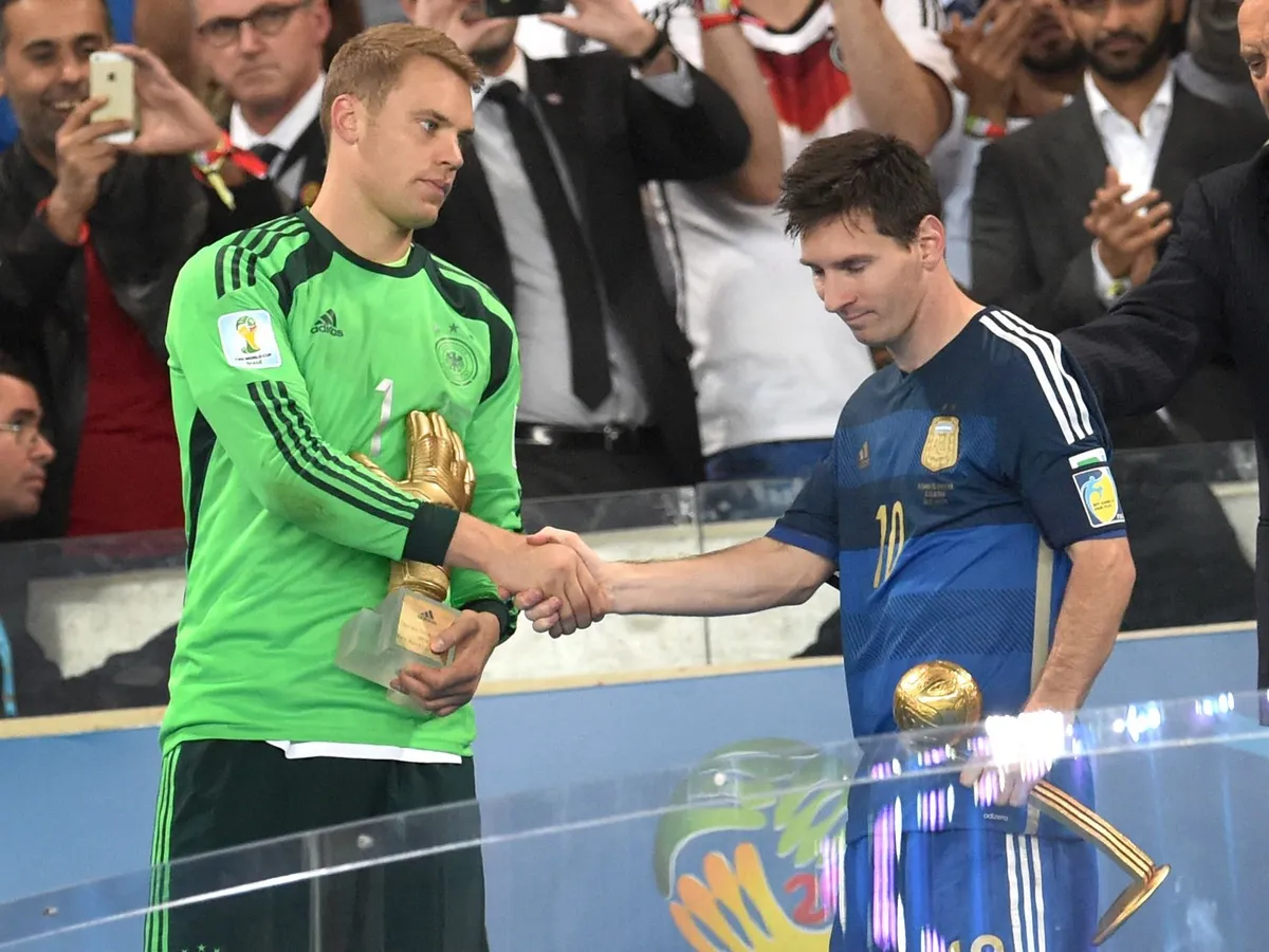 Goalkeeper Manuel Neuer of Germany (L) and Lionel Messi of Argentina shakes hand after being awarded as best goalkeeper with the golden glove and the best player with the golden ball after the FIFA World Cup 2014 final between Germany and Argentina at the Estadio do Maracana in Rio de Janeiro, Brazil, 13 July 2014. Photo: Andreas Gebert/dpa (RESTRICTIONS APPLY: Editorial Use Only, not used in association with any commercial entity - Images must not be used in any form of alert service or push service of any kind including via mobile alert services, downloads to mobile devices or MMS messaging - Images must appear as cstill images and must not emulate match action video footage - No alteration is made to, and no text or image is superimposed over, any published image which: (a) intentionally obscures or removes a sponsor identification image; or (b) adds or overlays the commercial identification of any third party which is not officially associated with the FIFA World Cup) EDITORIAL USE ONLY (Photo by ANDREAS GEBERT / dpa Picture-Alliance via AFP)