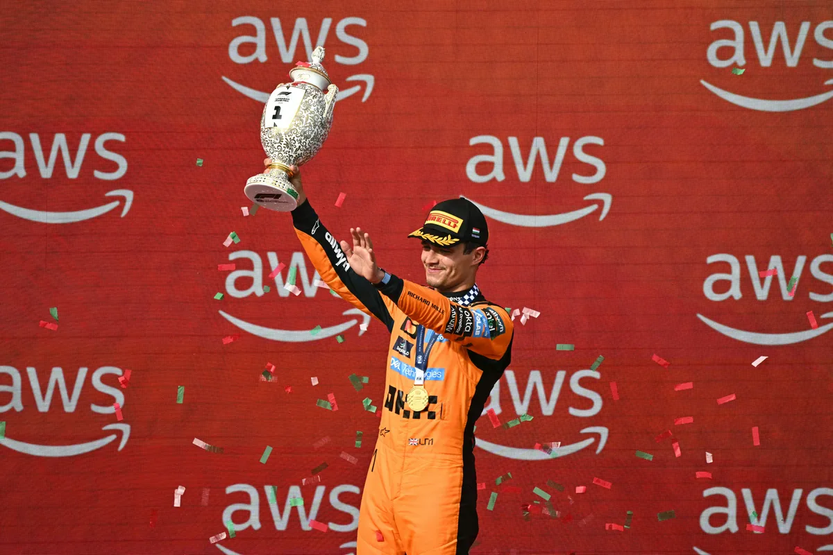 Winner McLaren's British driver Lando Norris celebrates with the trophy after the Formula One Hungarian Grand Prix at the Hungaroring racetrack in Mogyorod near Budapest, Hungary, on July 26, 2026. (Photo by Attila KISBENEDEK / AFP)