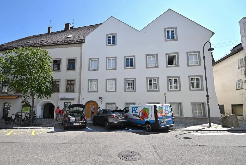 Picture taken on July 16, 2026 shows the birthhouse of former German dictator Adolf Hitler that is turned into a police station in Braunau am Inn, Austria. The controversial redesign of the house in the northern Austrian town of Braunau started in 2023. Following years of legal wrangling, the government took control of the dilapidated building in 2016 and decided to turn the house, where Hitler was born in 1889, into a police station that will be inaugurated on July 22, 2026. (Photo by KERSTIN JOENSSON / AFP)