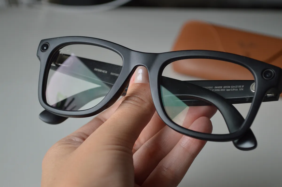 Warsaw, Poland - 12 October 2025: Hand holding modern Ray-Ban Meta smart glasses with integrated technology. Innovative wearable device combining classic eyewear design with AR, connectivity feature