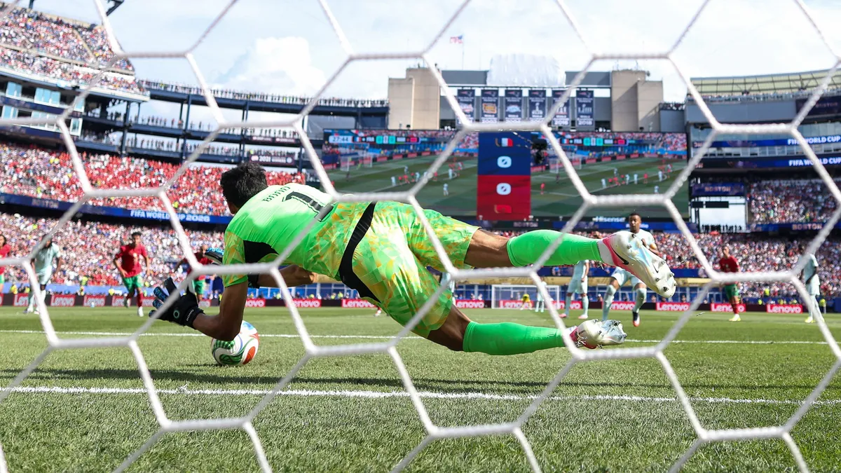 FOXBOROUGH, MASSACHUSETTS - JULY 09: (EDITOR'S NOTE: Image was captured using a remote camera from behind the goal.) Yassine Bounou #1 of Morocco saves a penalty by Kylian Mbappe #10 of France during the FIFA World Cup 2026 Quarter Final match between France and Morocco at Boston Stadium on July 09, 2026 in Foxborough, Massachusetts.   Lars Baron/Getty Images/AFP (Photo by Lars Baron / GETTY IMAGES NORTH AMERICA / Getty Images via AFP)