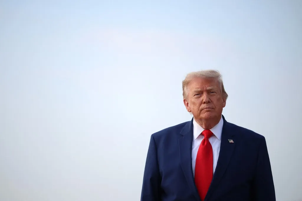 JOINT BASE ANDREWS, MARYLAND - JULY 22: U.S. President Donald Trump looks to reporters after getting off Air Force One on July 22, 2026 at Joint Base Andrews, Maryland. Trump is returning from attending a dignified transfer at Dover Air Force Base and a rally in Georgia. Kevin Dietsch/Getty Images/AFP (Photo by Kevin Dietsch / GETTY IMAGES NORTH AMERICA / Getty Images via AFP)