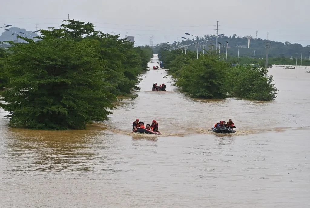 (260708) -- GUIGANG, July 8, 2026 (Xinhua) -- Rescuers evacuate stranded teachers and students at Xijiang education park in Guigang City, south China's Guangxi Zhuang Autonomous Region, July 8, 2026. The torrential rains caused by Typhoon Maysak left many school personnel and students trapped by floods at Xijiang education park in Guigang. Local authorities organized rescue forces to evacuate stranded teachers and students here on Wednesday. (Xinhua/Zhou Hua) (Photo by Zhou Hua / Xinhua via AFP)