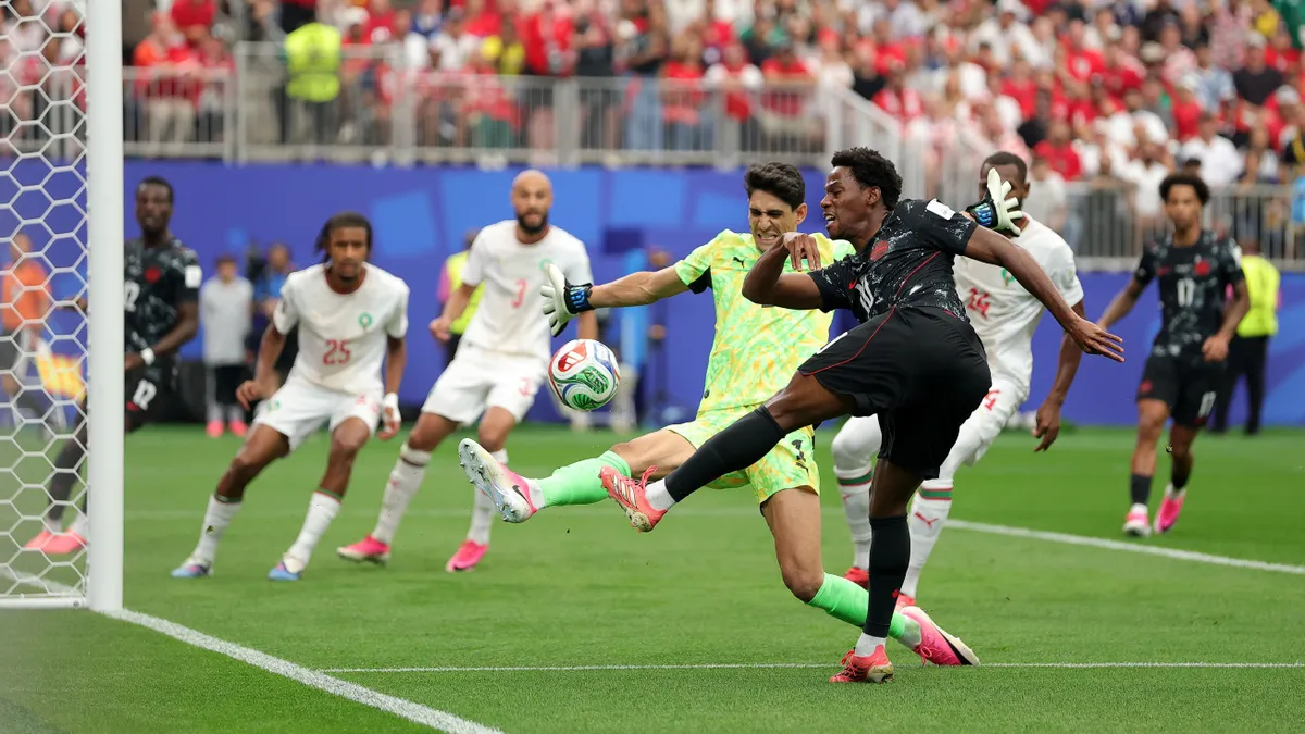 HOUSTON, TEXAS - JULY 04: Jonathan David #10 of Canada shoots against Yassine Bounou #1 of Morocco during the FIFA World Cup 2026 Round of 16 match between Canada and Morocco at Houston Stadium on July 04, 2026 in Houston, Texas. (Photo by Alex Slitz/Getty Images)