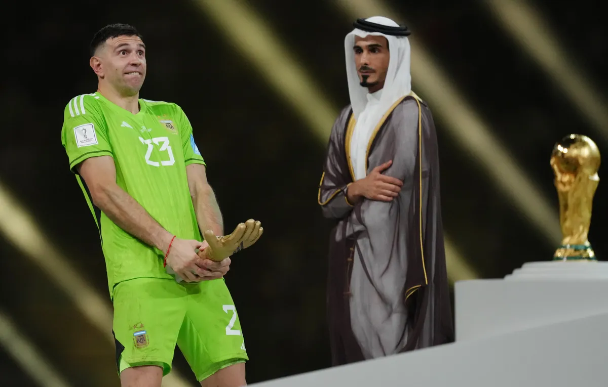 Argentina goalkeeper Emiliano Martinez celebrates with the Golden Glove award after being presented with it following victory in the FIFA World Cup final at Lusail Stadium, Qatar. Picture date: Sunday December 18, 2022.